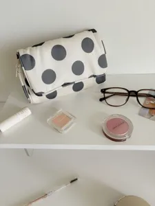 Large polka dot canvas cosmetic bag, portable travel storage pouch with stylish aesthetic design.