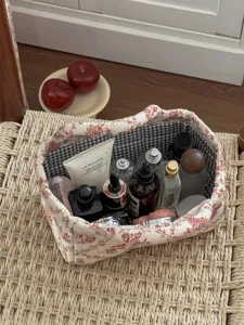 French style quilted fabric storage basket with red floral pattern and black white grid interior.