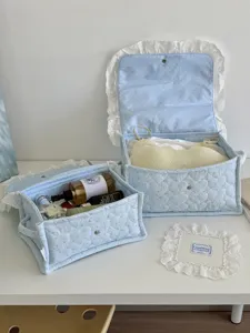 Light blue quilted storage basket with lace trim, aesthetic desktop organizer for bedroom.