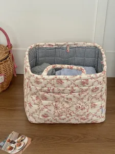 French vintage style fabric storage basket with toile de jouy floral print and gingham interior.