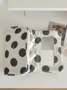 Black and white polka dot canvas cosmetic bag with mirror travel makeup storage pouch.