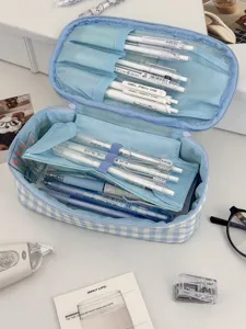 Blue plaid pencil case detail showing multi-compartment pen slots and mesh pocket storage.