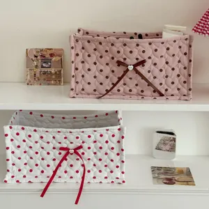 Cute quilted storage basket with polka dots and bow, perfect for desktop organization and home decor.