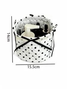 White quilted polka dot round storage basket with black bow and lace trim, detailed view.