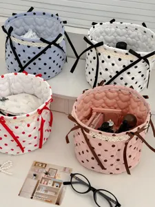 Quilted fabric storage basket with cute bows and polka dots, perfect for desktop organization.