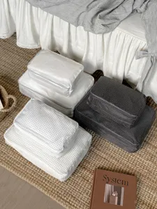 Detailed view of grid packing cubes set for travel luggage organization and storage solutions.