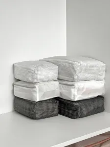 Minimalist grid travel storage bag set for luggage organization, portable and space-saving.