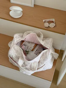 Quilted floral duffel bag, spacious travel tote with pink lining for daily commute.