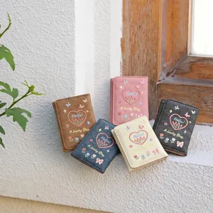 Denim trifold wallet featuring cute embroidered heart and flower details, compact coin purse design.