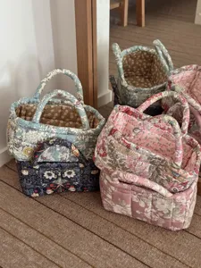 Quilted fabric storage basket floral print desktop organizer and laundry hamper for home decor.