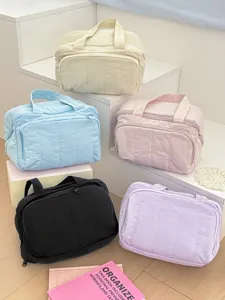 Detailed view of soft quilted nylon cosmetic bags in multi-colors, perfect portable storage.