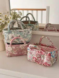 Quilted fabric storage basket, floral desktop organizer with handles, cozy home decor detail.