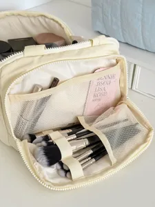 Spacious nylon makeup bag with brush holders and mesh compartments for daily cosmetic organization.