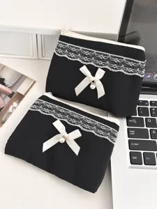 Bolso cosmético acolchado negro de encaje con lazo y perla para el almacenamiento diario