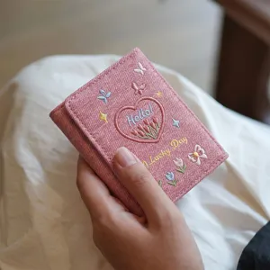 Pink denim trifold wallet for women with cute embroidered heart tulips and butterflies.