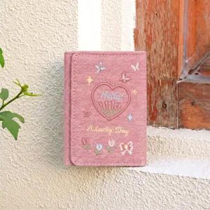Close-up detail of pink denim trifold wallet featuring delicate embroidered tulips and cute hearts.