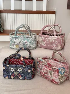 Quilted fabric storage basket, floral print desktop organizer and laundry hamper for home decor.