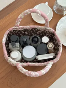 Quilted fabric storage basket, pink floral desktop organizer with handles for home sundries.