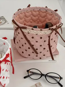 Pink quilted storage basket with brown polka dots, cute bow and lace trim for desktop organization.