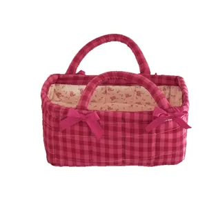 Pink checkered quilted storage basket with cute bows and floral lining for home organization.
