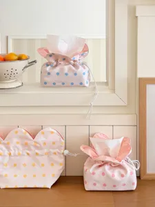 Detailed close-up view of pink polka dot fabric tissue box cover with cute floral edges.