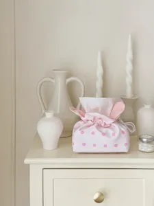 Close up of a cute pink polka dot fabric tissue box, perfect for home desktop decoration.