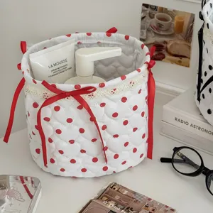 Quilted fabric storage basket with red polka dots, cute bows and lace trim for desktop organization.