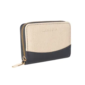 Detail view of a chic color-blocked zipper card holder with gold hardware and canvas texture.