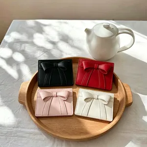 Detailed scene shot of stylish bow cardholders, cute thin PU leather short wallets available.