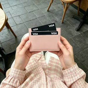 Close-up view of minimalist pink PU leather card holder, slim card case with multiple slots.