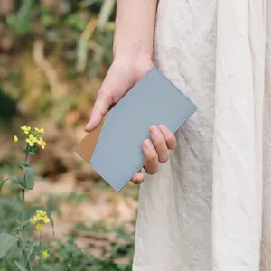 Detailed view of the ultra-thin minimalist two-tone leather wallet in outdoor scene.