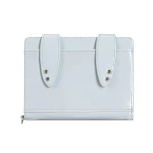 Detail view of light blue glossy passport wallet featuring cute bunny ear flaps and metal eyelets.