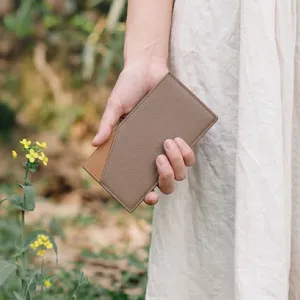 Minimalist bi-fold leather card wallet detail view, elegant two-tone slim design for daily use