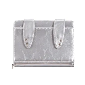 Detailed view of silver metallic passport holder with cute bunny ear design and metal eyelet accents.