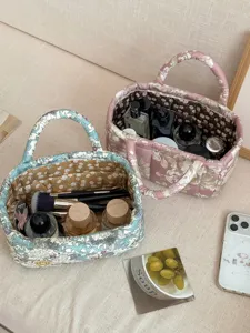 Quilted fabric storage basket with floral print, desktop organizer for cosmetics and sundries.