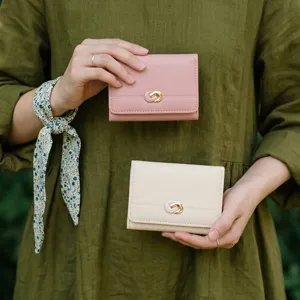 Minimalist tri-fold women wallet with metal D-buckle, multi card slots and coin purse detail view.