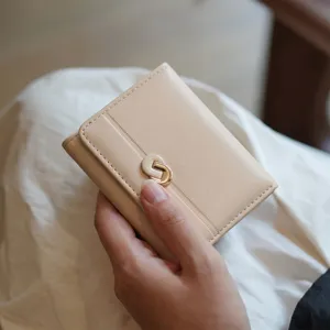 Elegant minimalist trifold wallet for women with chic metal clasp, premium PU leather purse.