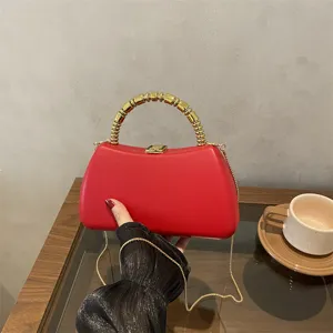 Red PU hard shell box bag with metallic beaded handle and elegant chain strap for evening party.