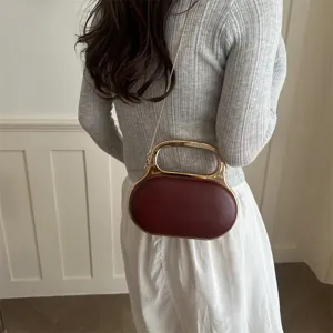 Chic acrylic evening handbag with metal handle and chain strap, elegant shoulder bag.