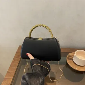 Black hardshell box clutch bag with unique golden beaded metal handle and chain strap detail