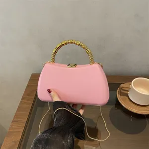 Chic pink hard shell evening clutch bag with luxury gold beaded handle and chain strap for women.