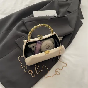 Elegant PU hard shell clutch bag with gold bead handle and chain strap for women evening party.