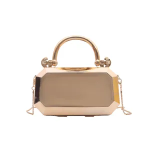 Gold metallic geometric evening clutch bag detail, stylish luxury shoulder chain handbag.