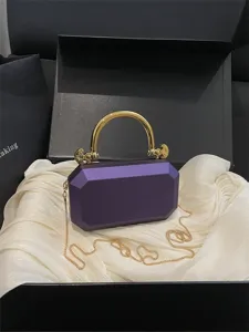Elegant purple acrylic box evening bag with luxurious gold handle and chain strap.