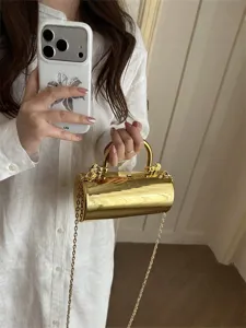 Chic borsa da sera cilindrica metallica dorata con manico e catena per la moda estiva.