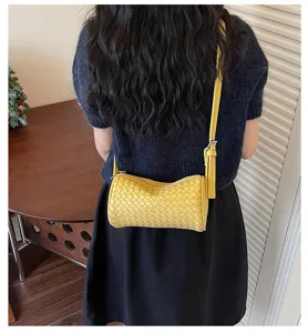 Yellow woven cylinder crossbody bag for women, stylish leather shoulder bag for summer.