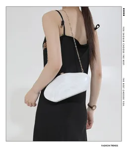 Detail view of the elegant acrylic hard case clutch bag with metal chain strap for women.