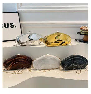 Detailed view of irregular acrylic hard shell clutch evening bags with chain straps in multiple colors.