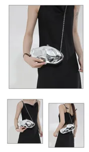 Close-up detail of the irregular silver acrylic hard-shell evening clutch bag with chain strap.