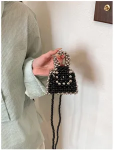Handmade beaded mini crossbody bag, fashionable black and silver pearl handbag for women.